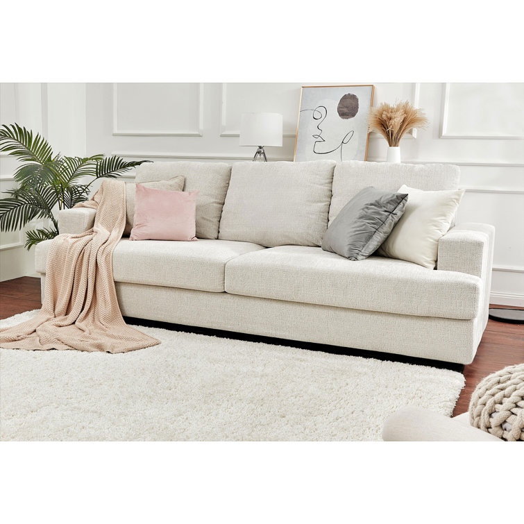 Modern style sofa with contrasting tufted back cushions