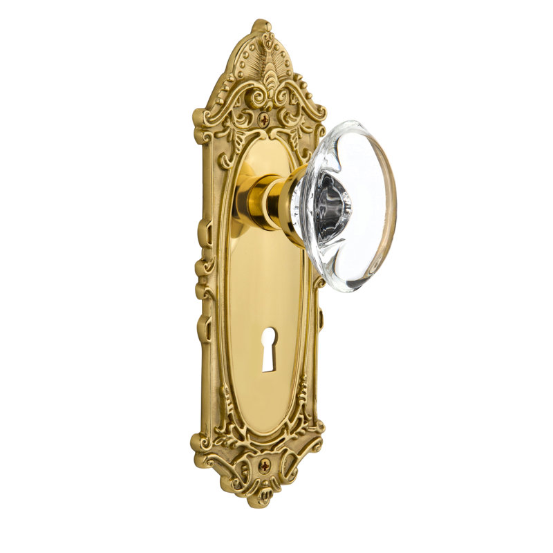 Plaque victorienne avec trou de serrure décoratif et poignée de porte ovale en cristal transparent, 2 3/4 po, Laiton poli