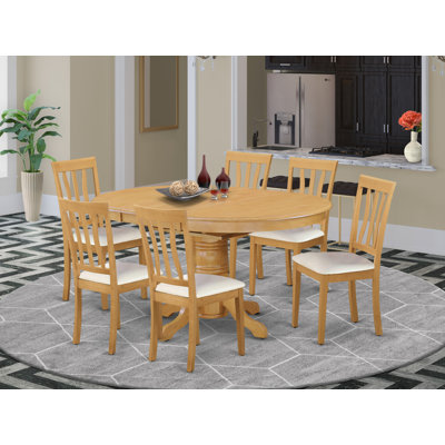 L'ensemble de salle à manger 7 pièces pour 6 personnes comprend une table de cuisine ovale avec rallonge papillon et 4 chaises de cuisine en similicuir, chêne