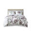 Édredon et drap mauve à motif floral pour une chambre douillette avec taupe