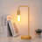 Lampe de table avec cadre doré et base en bois
