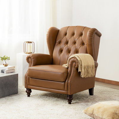 Fauteuil à oreilles en cuir véritable avec capitonnage à boutons Amyri