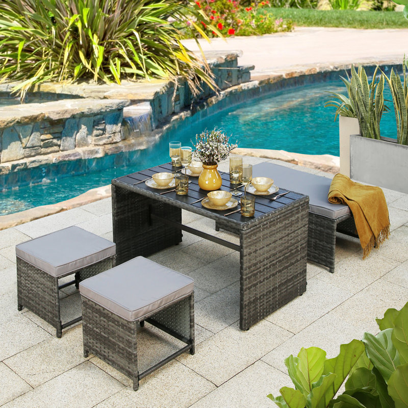 Kiwon 4 - Person Wicker Patio Dining Set with Rectangular Table , Cushions Included