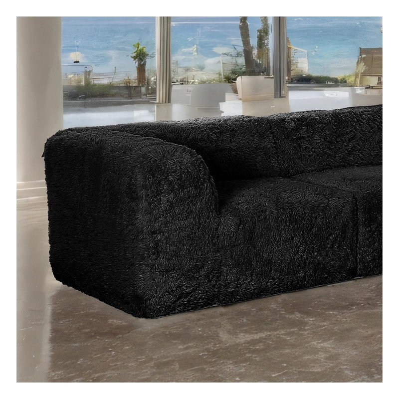 Fauteuils d'angle modulaires en L, en mousse haute densité compressée, couleur noire, avec poufs et revêtement en fausse fourrure.