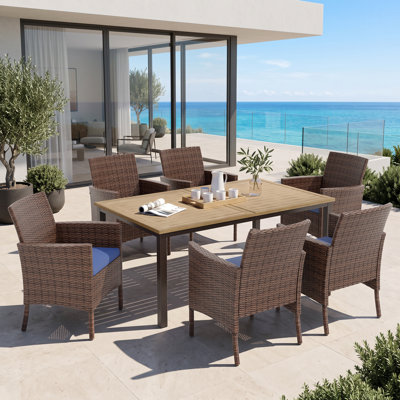 Leonard Rectangular 6 - Person 64" Long Dining Set with Cushions and Umbrella Hole