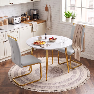42"–54" Round to Oval Extendable Dining Set with Faux Leather Cantilever Chairs