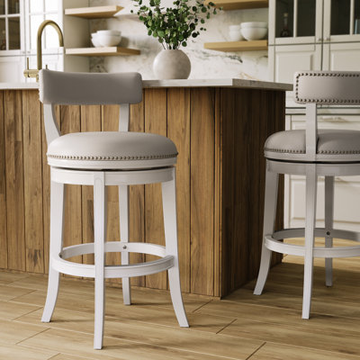 Tabouret de comptoir pivotant rembourré avec structure en bois massif Carollynn