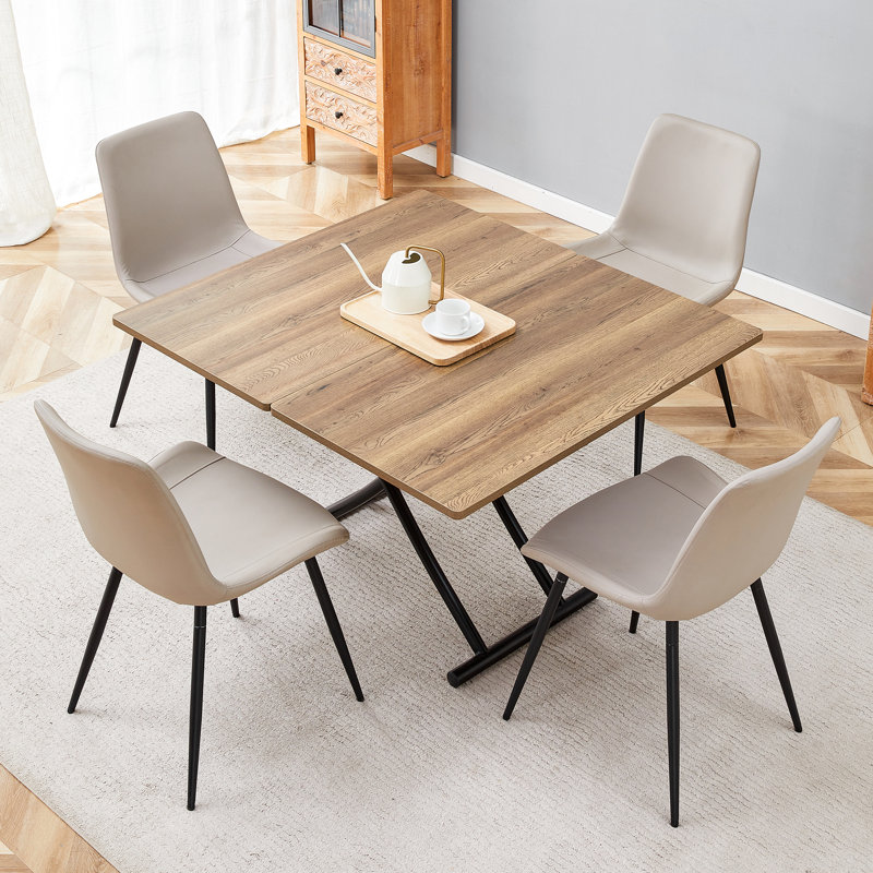 Ensemble de table de salle à manger à hauteur réglable avec plateau en bois aggloméré et pieds en métal noir, style multifonctionnel moderne avec 4 chaises en cuir pu pour la salle à manger, le café ou le bureau