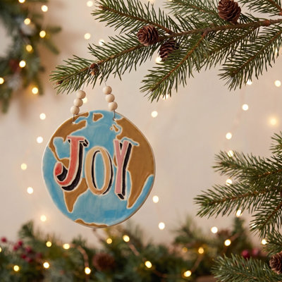 Round Handmade Stoneware Ornament with Wax Relief "Joy" in Linen Bag