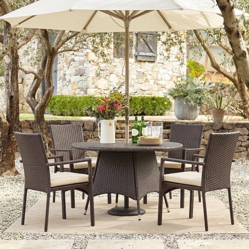 Arturas 4 - Person Wicker Patio Dining Set with Round Table , Cushions Included, Brown