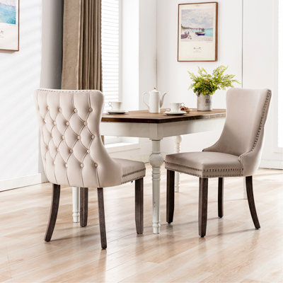 Chaises de salle à manger rembourrées beiges (2 pièces). Bois massif. Haut dossier confortable. Coussin rembourré en mousse. Chevilles réglables. Base en bois Sw8809bg.