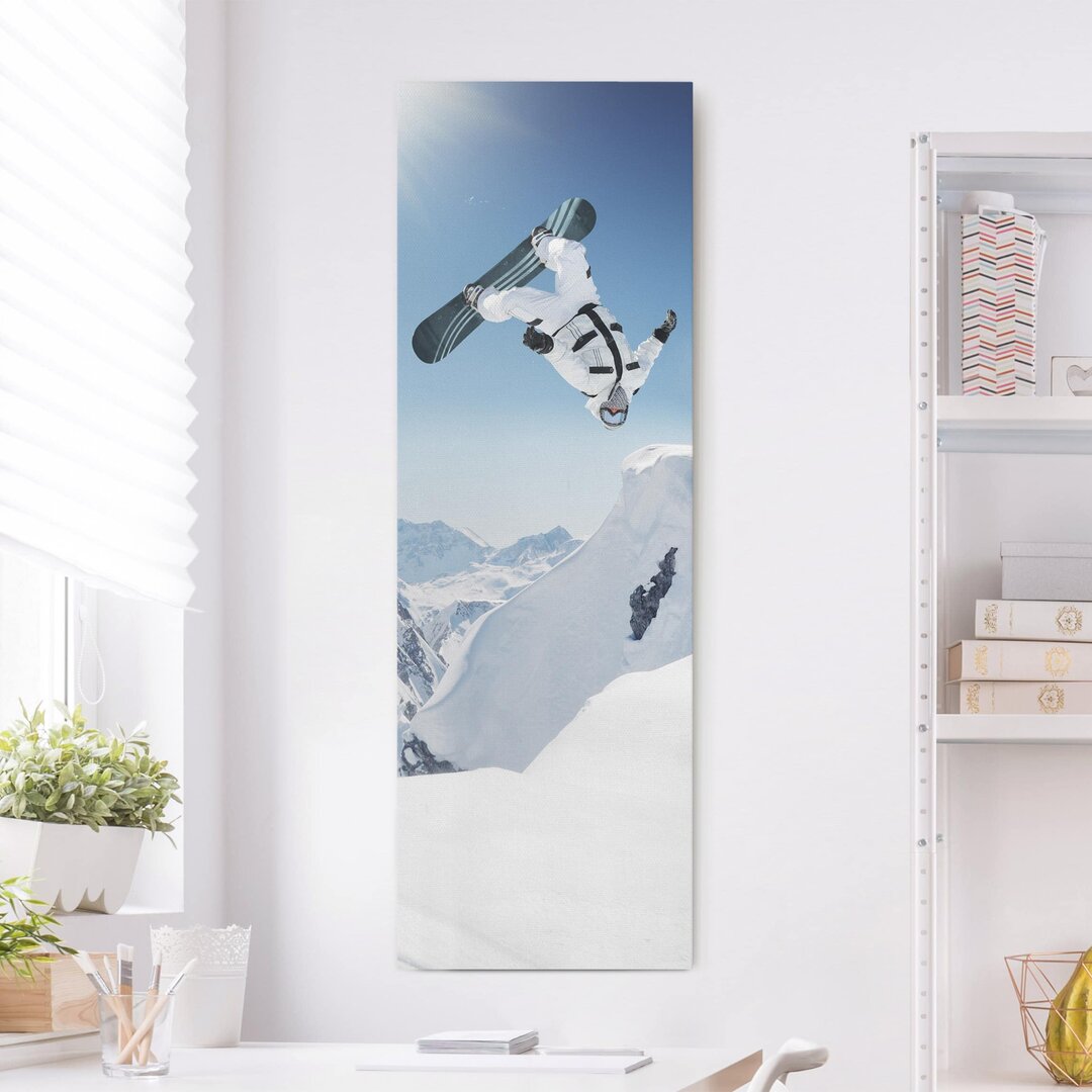 Leinwandbild Fliegender Snowboarder