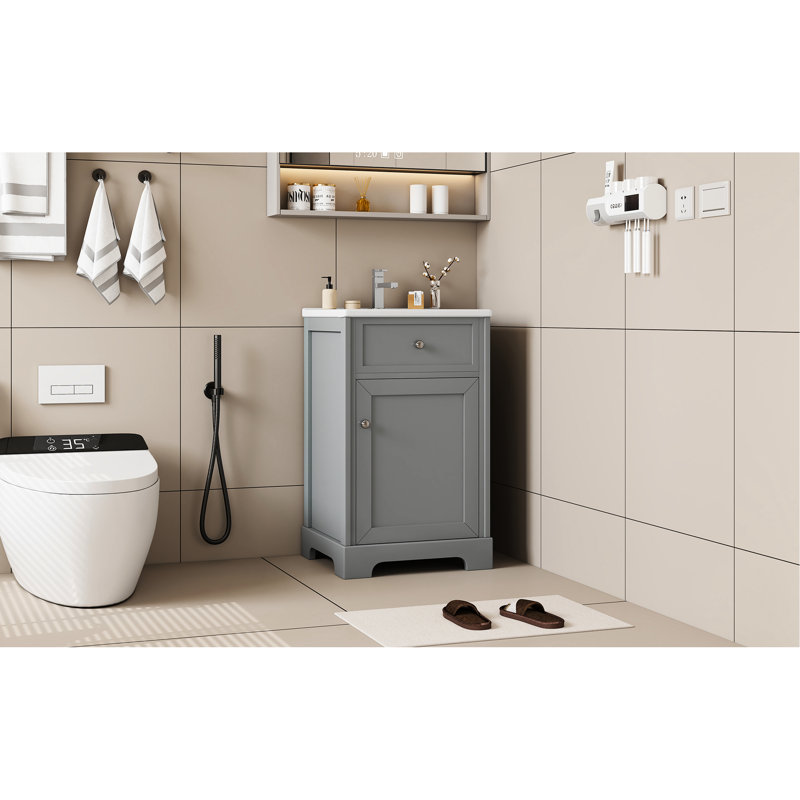 Meuble-lavabo de salle de bain de 50 cm (20 po) de couleur grise, avec un seul lavabo et une poignée de porte ronde. Style moderne avec lavabo en céramique blanche et grand espace de rangement pour une salle de bain bien rangée.