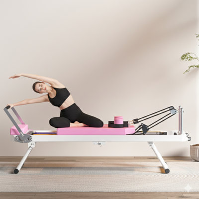 Lit pliant Pilates Core pour un usage domestique, offrant une performance de haute qualité à égalité avec l'équipement de remise en forme commercial utilisé dans les studios de yoga, disponible en rose.