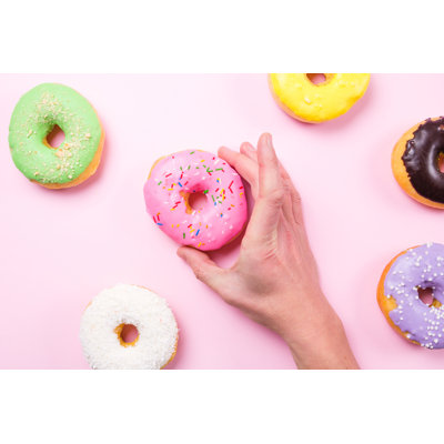 Hand Taking Pink Donut - Wrapped Canvas Print
