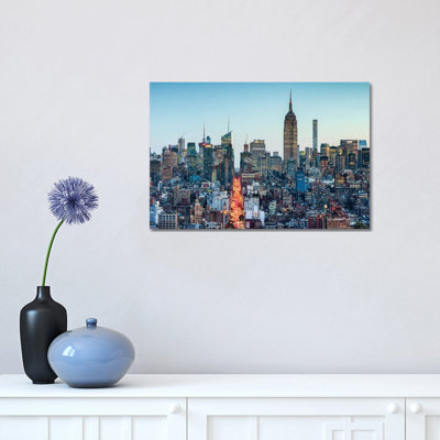 " Manhattan Skyline With Empire State Building At Dusk " by Jan Becke