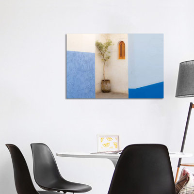 Africa, Morocco, Asilah. Potted Tree And Painted Walls. by Jaynes Gallery - Wrapped Canvas Print