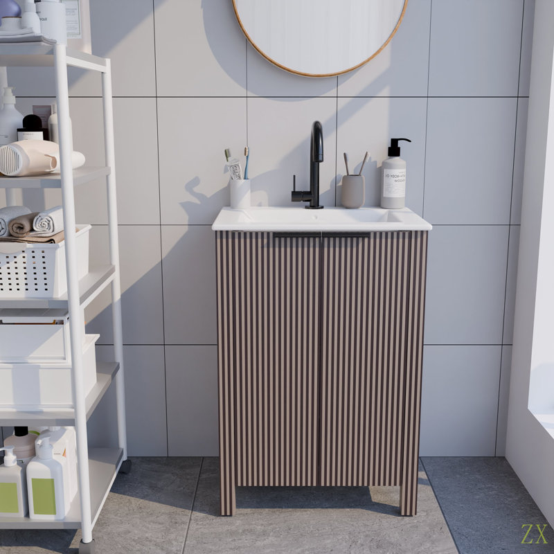 Une armoire de salle de bain sur pied de 30 pouces, jumelée à un lavabo en céramique, est pliable et facile à transporter.