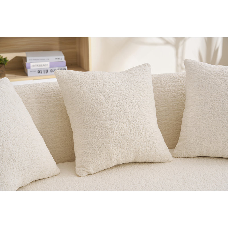Canapé incurvé moderne sans dossier avec dossier amélioré et revêtement en chenille pour une assise confortable dans des espaces compacts.