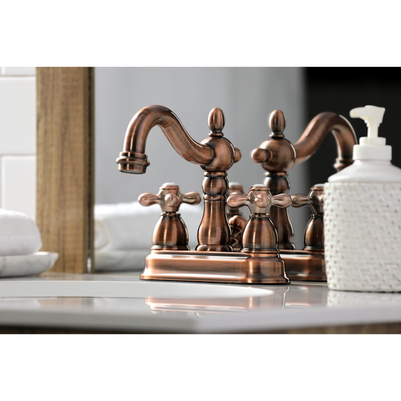 Robinet de salle de bain central à deux poignées et 3 trous à fixation sur le comptoir de 4 po avec bonde escamotable en plastique Kingston Brass Heritage