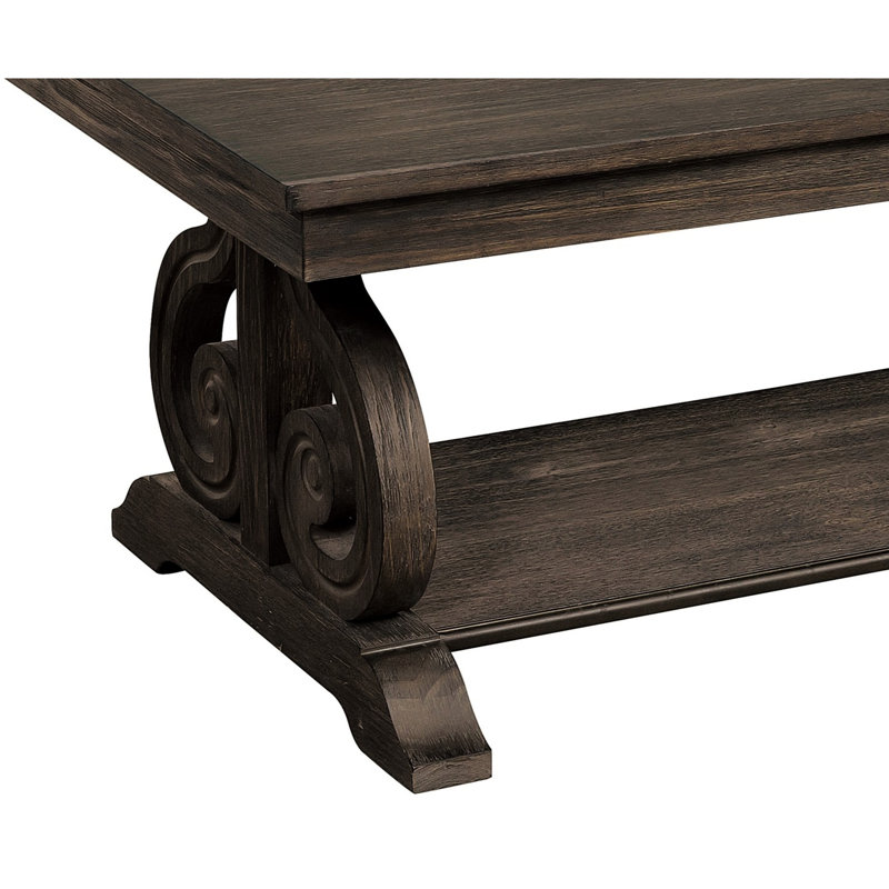 Table à finition chêne foncé avec base à volutes et tablette de rangement pratique