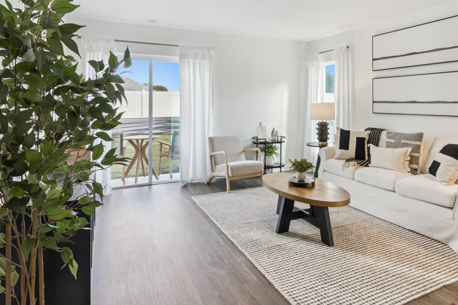Living room with white sofa, wood coffee table, and neutral tones.