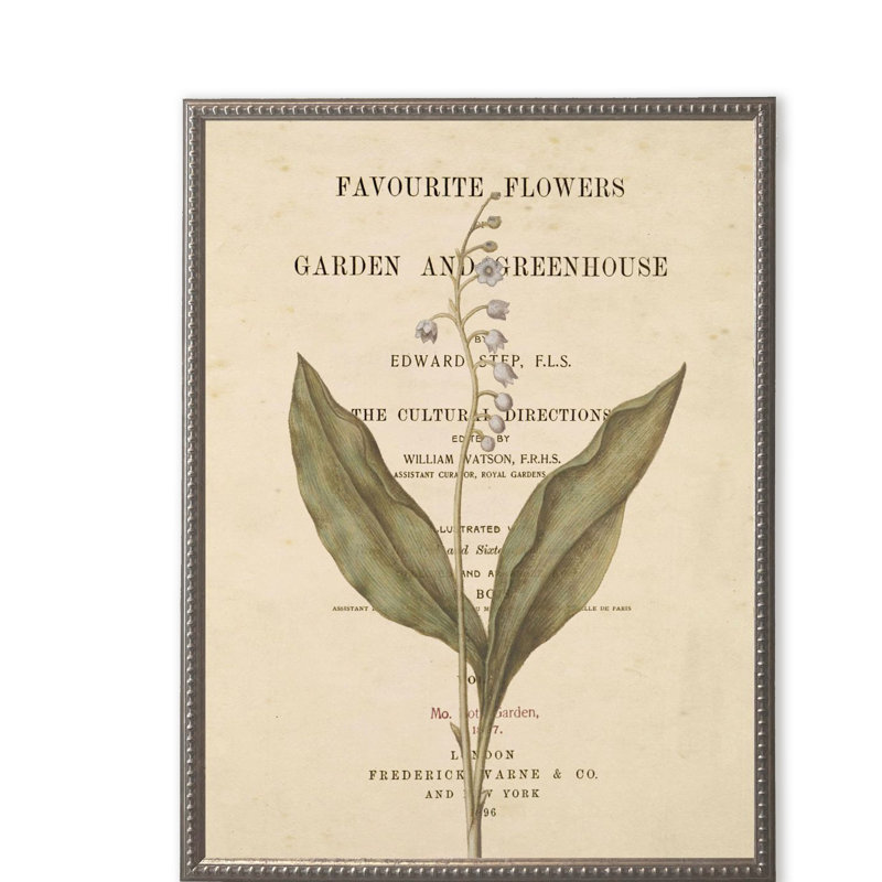 Fleurs blanches sur une page de livre dans un cadre perlé argenté
