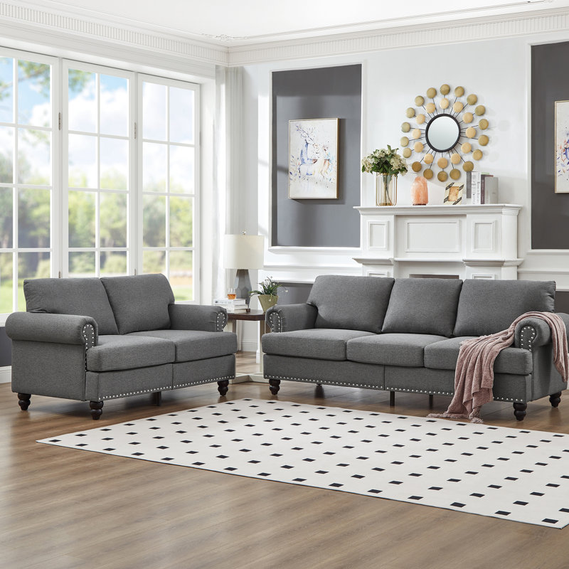 Canapé en tissu 5 places moderne et classique pour le salon, revêtement en gris, rond avec clous argentés, structure en bois massif, coussins amovibles, rangement sous les sièges, clous, structure