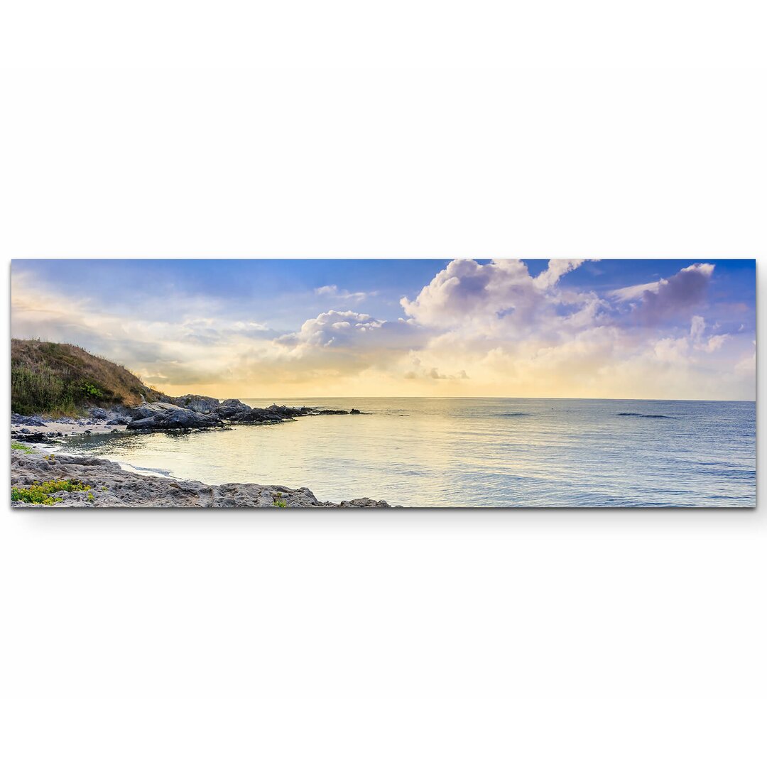 LeinwandbildÂ Steiniger Strand am Abend