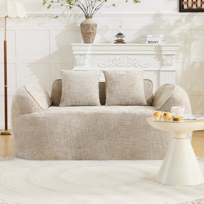 Curved two - person compress  sofa. It has armrests on both sides, comes with two pillows, is suitable for small - sized apartments, and can be placed in the living room or bedroom.