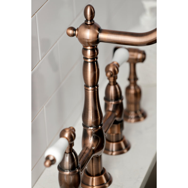 Kingston Brass Heritage Two-Handle 4-Hole Deck Mount Bridge Kitchen Faucet with Brass Side Sprayer, Antique Copper