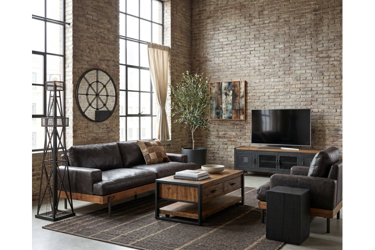 industrial-style living room in a loft apartment with exposed brick walls and concrete floors