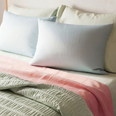 Close up of a white blanket with a woven circle pattern.