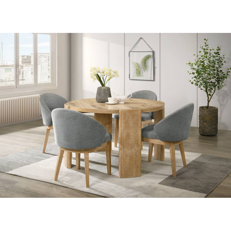 Ensemble de salle à manger rond et moderne avec table en bois et quatre chaises rembourrées à dossier courbé