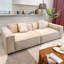Canapé modulaire en cuir véritable couleur crème avec coussins.-1157689894