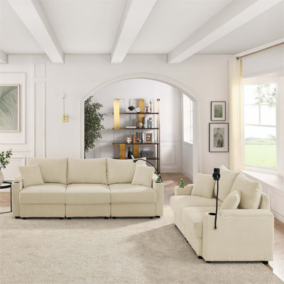 Ensemble de canapé confortable et fonctionnel avec compartiments de rangement et porte-gobelets, parfait pour une expérience de salon relaxante
