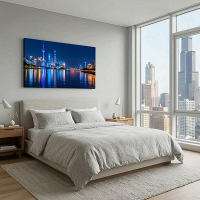 Illuminated City Skyline with River Reflections at Night Canvas Wall Art