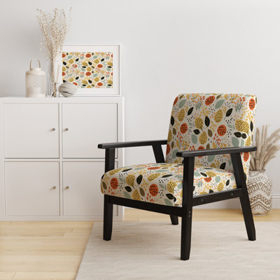 Fauteuil rembourré en velours de couleur douce avec motif de feuilles tropicales