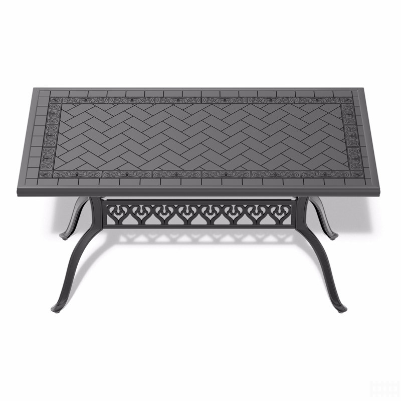 Table de salle à manger en fonte d'aluminium avec cadre noir et texture sculptée sur le plateau de table