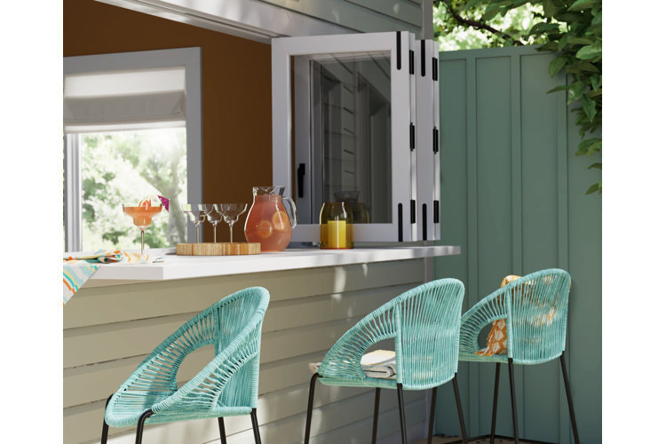 Open window with a built-in bar counter and three blue bar stools pulled up to the counter.