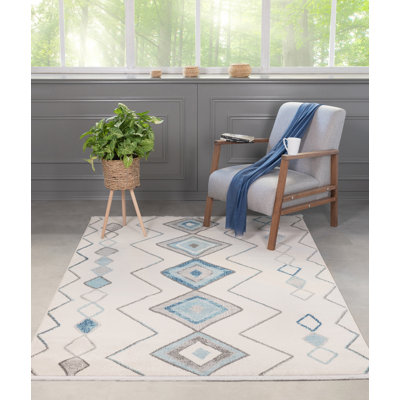 Tapis géométrique rectangulaire bleu / crème en polypropylène tissé à la machine