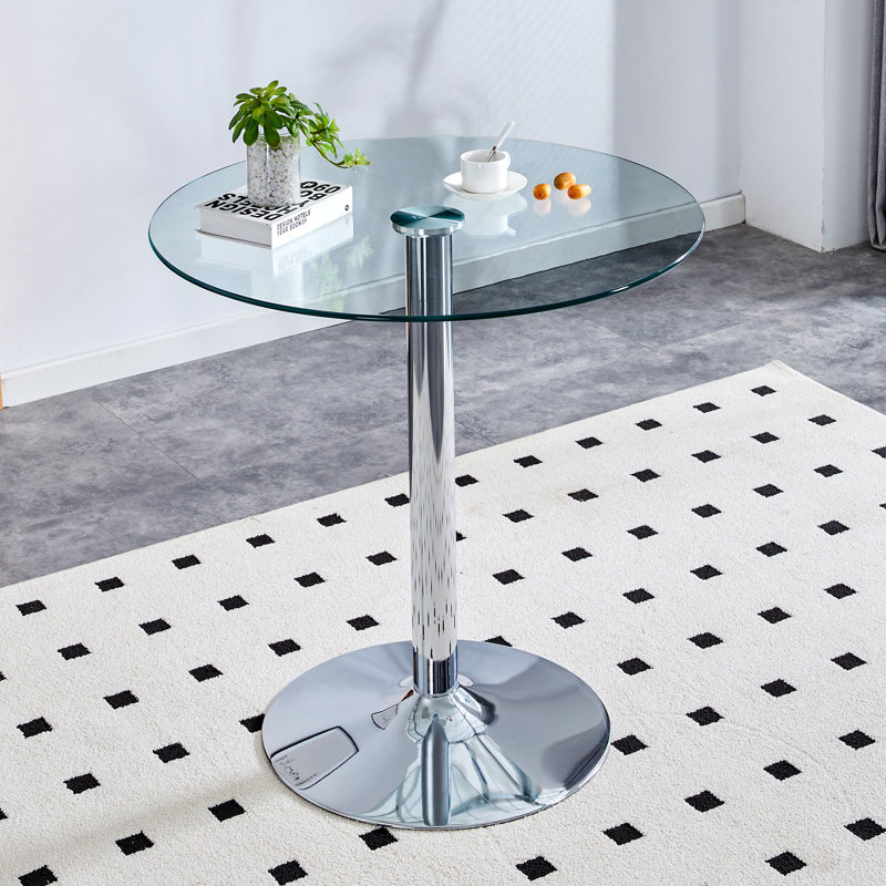 The modern and simple round glass dining table is equipped with silver-plated legs and is suitable for various scenarios