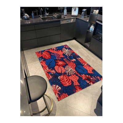 Tapis décoratif bleu à motif de feuille rouge
