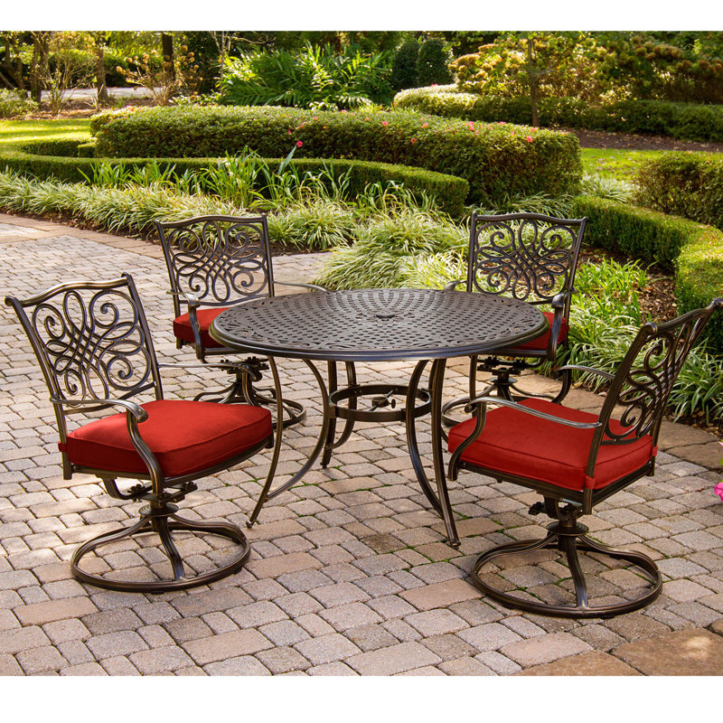 Carleton 4 - Person Patio Dining Set with Round Table , Cushions Included, Oil Rubbed Bronze/Red
