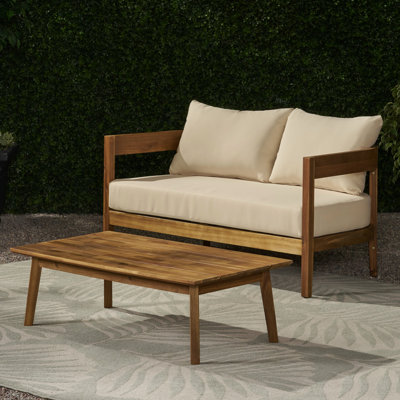 Élégante table basse en bois et bois avec coussins d'eau et mobilier d'extérieur de forme épurée - Style