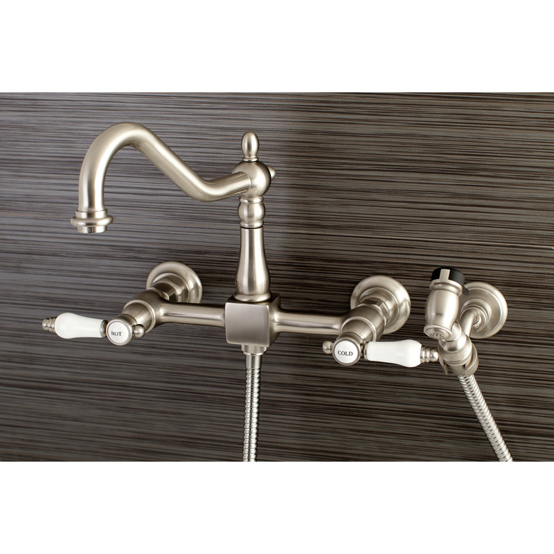 Kingston Brass Essex Double-Handle Wall-Mount Bridge Kitchen Faucet, Brushed Nickel, With Side Spray, Porcelain Lever 