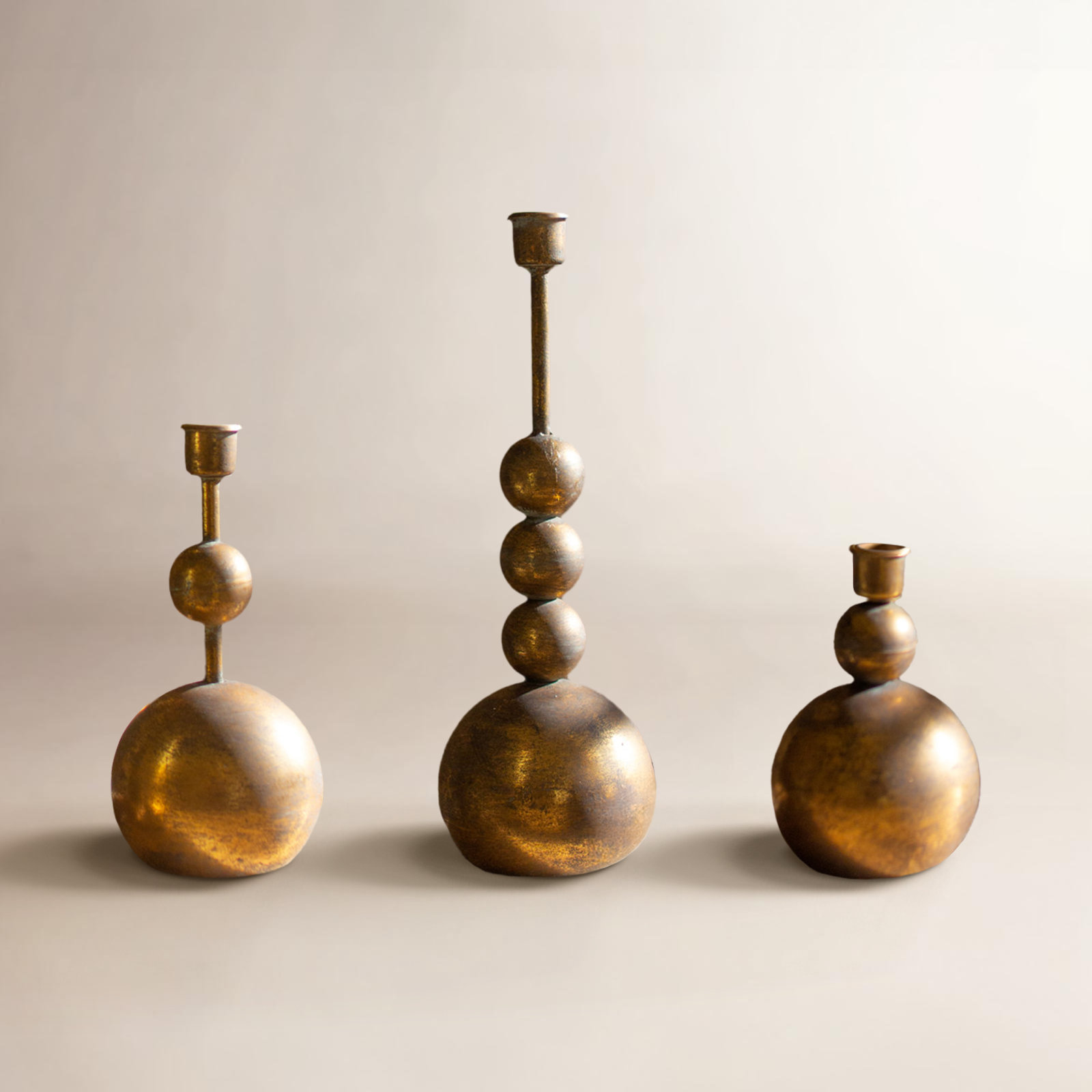 SET OF THREE ANTIQUE BRASS TAPER CANDLE HOLDERS