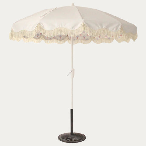 White outdoor umbrella with fringe detail