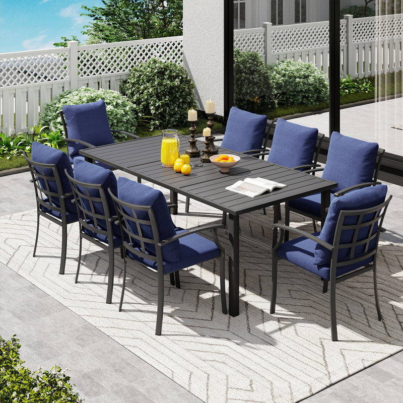 Ensemble repas de patio en métal noir 9 pièces avec table rectangulaire et coussins bleus Maynard, Bleu