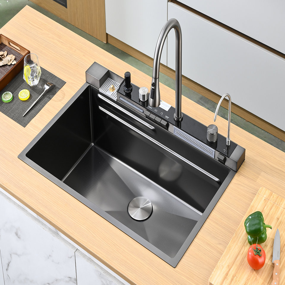Black stainless steel workstation kitchen sink with integrated pull-down faucet, soap dispenser, and purified water tap set into a light wood countertop.
